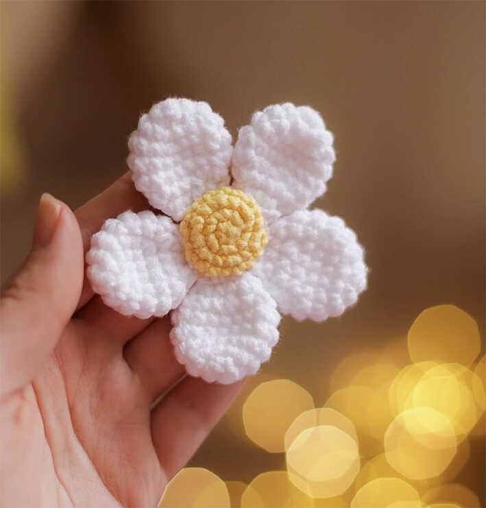 small crochet daisy flower amigurumi held in hand cute handmade easter decoration toy