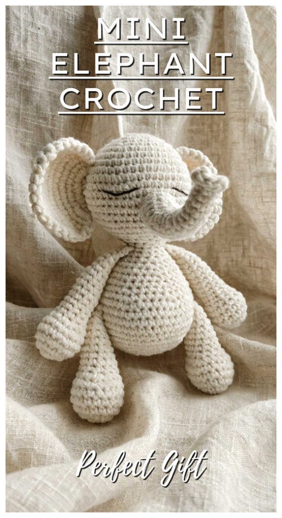 mini crochet elephant amigurumi doll full body cute handmade elephant toy on fabric