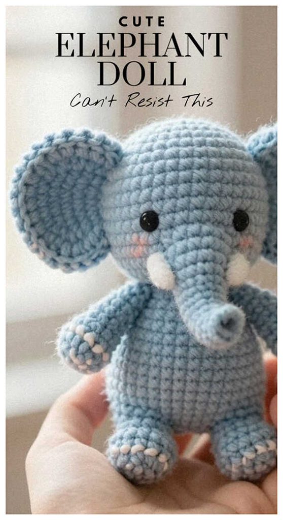 cute blue crochet elephant amigurumi held in hand small handmade elephant doll toy
