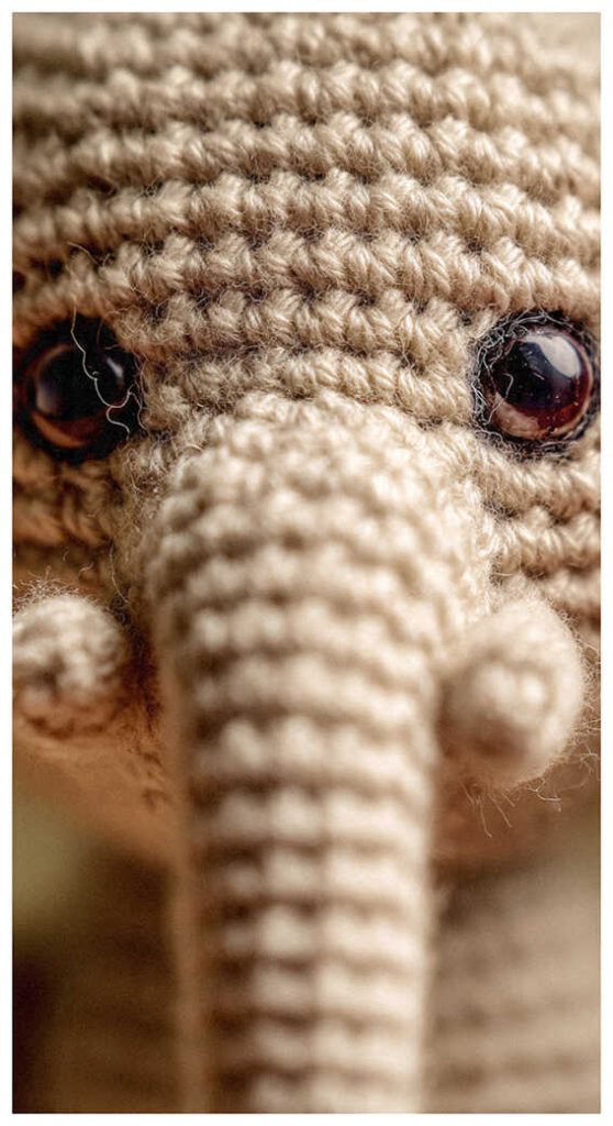 crochet elephant amigurumi face close up cute handmade elephant toy detailed texture