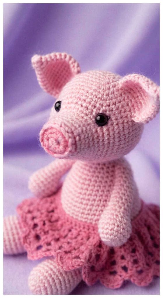 Amigurumi pig doll with pink skirt close view, soft crochet pig plush design