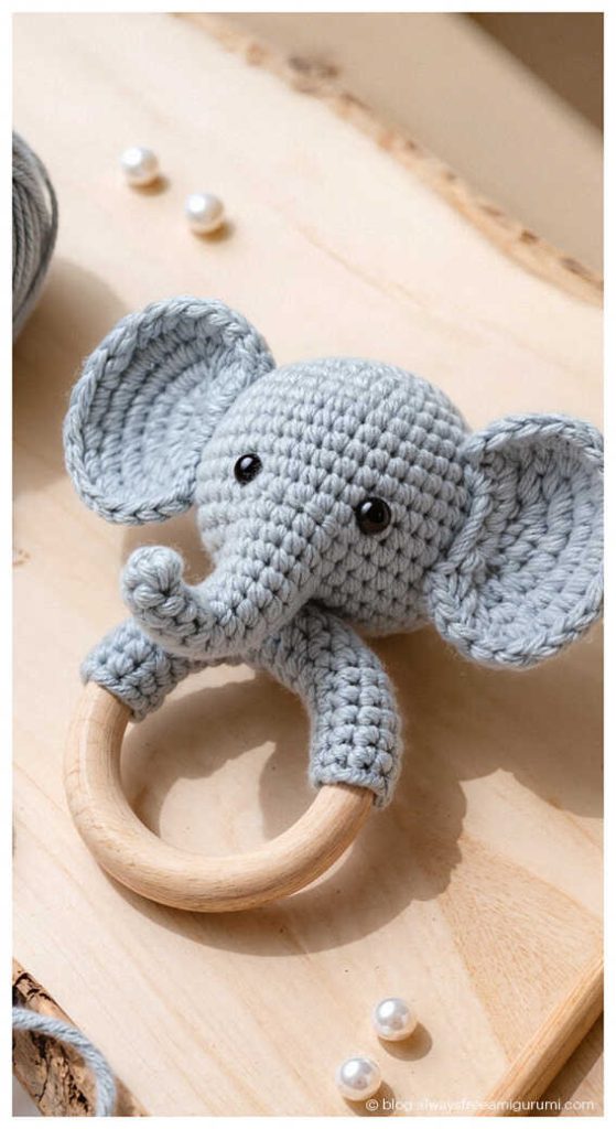 crochet elephant baby rattle with wooden ring small handmade baby toy on wooden board