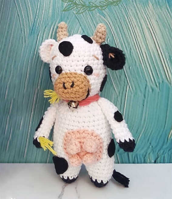 free cow amigurumi pattern soft plush cow crochet toy with black and white details and bell collar