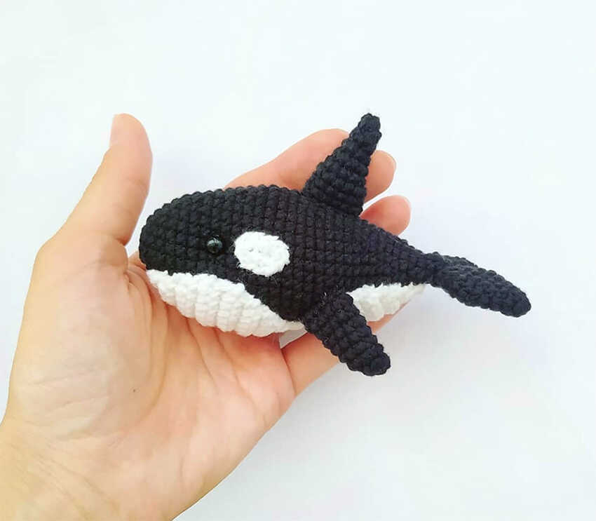 Free orca amigurumi crochet pattern featuring a small handmade black and white whale