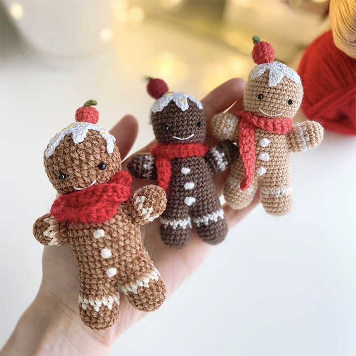 Gingerbread man amigurumi crochet plush toys held in hand