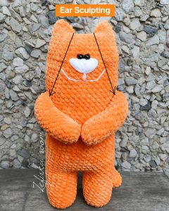 kitten amigurumi ear sculpting tutorial showing ear shaping detail on plush crochet cat